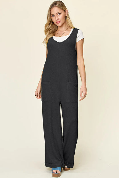 Trendsi Double Take full size sleeveless jumpsuit with textured fabric and wide-leg style, displayed on a hanger.