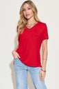 Basic Bae full size V-neck high-low T-shirt by Trendsi, showing the front view with a relaxed fit and V-neck design.
