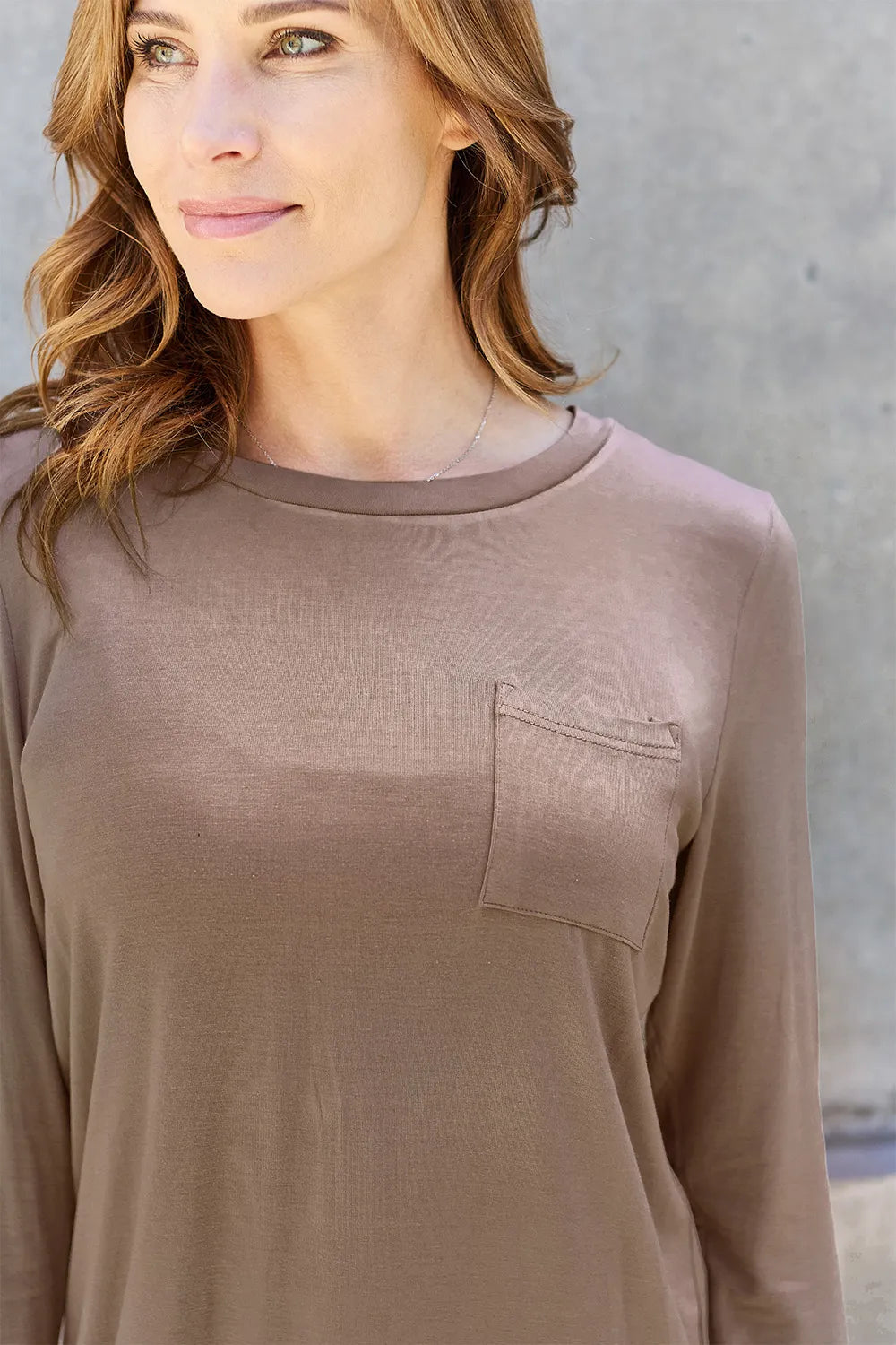 Basic Bae full-size round neck long sleeve top by Trendsi, shown in a natural pose, highlighting its classic design and comfortable fit.