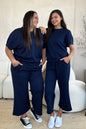Trendsi Double Take full size textured short sleeve top and matching pants set, stylish and comfortable for casual wear.