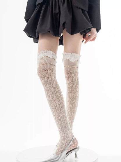 Black lace over-the-knee hollow-out stockings with intricate floral patterns, designed by Trendsi for a stylish, alluring look.