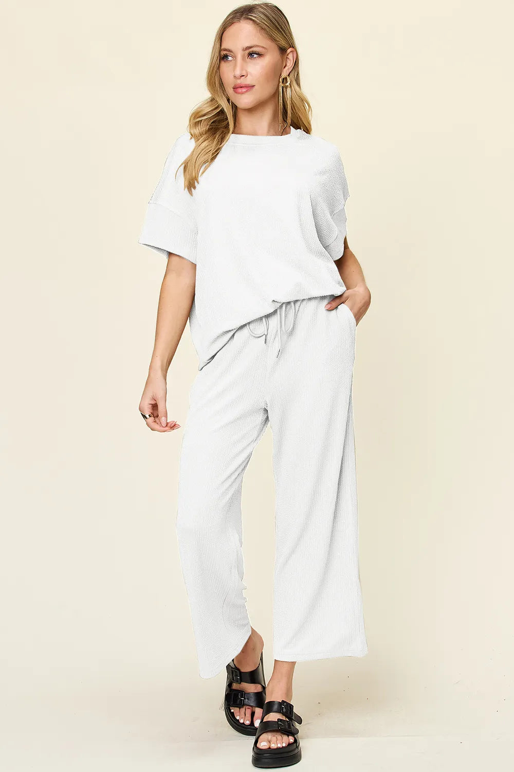 Trendsi double take full size textured round neck short sleeve T-shirt paired with wide-leg pants, casual and comfortable outfit.
