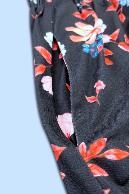 Printed sleeveless casual dress by Trendsi featuring front buttons, ruched waist, side slit, and pockets.