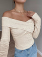 Apricot crisscross off-shoulder long sleeve top by Trendsi, featuring a stylish design and fitted long sleeves.