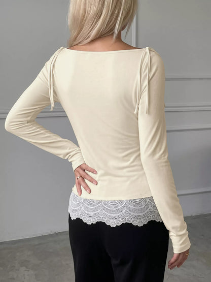 Apricot long sleeve T-shirt with lace trim details from Trendsi, featuring a casual fit and elegant lace accents on the sleeves.