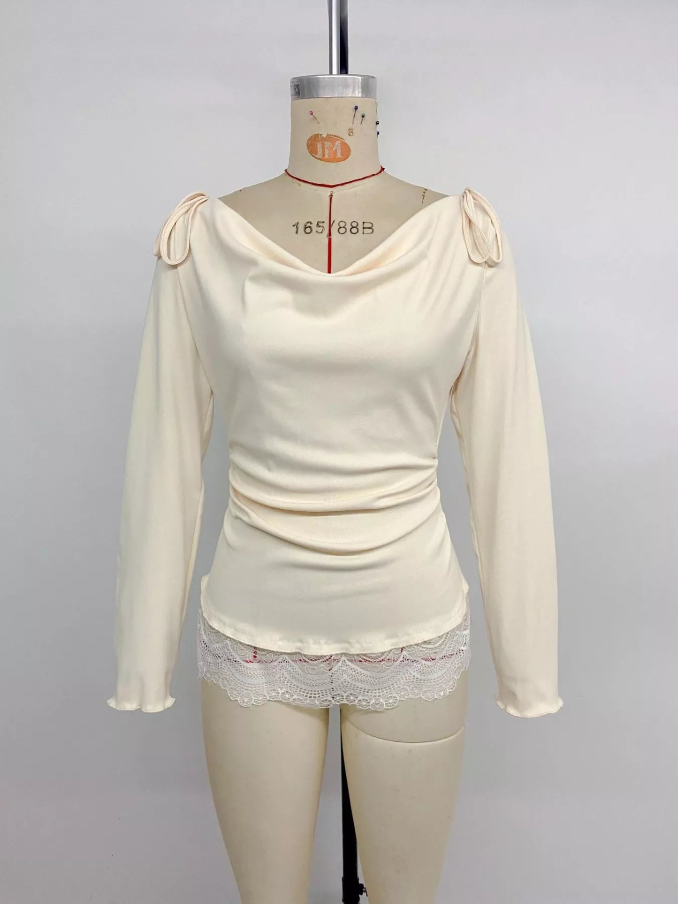 Apricot lace trim long sleeve T-shirt by Trendsi, featuring a classic fit and delicate lace accents on the sleeves.