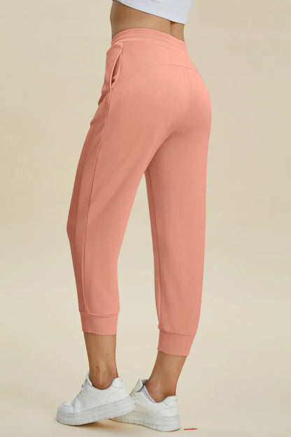 Trendsi Basic Bae Full Size Air Scuba Drawstring High Waist Cropped Pants in black, featuring a high waist and relaxed fit.