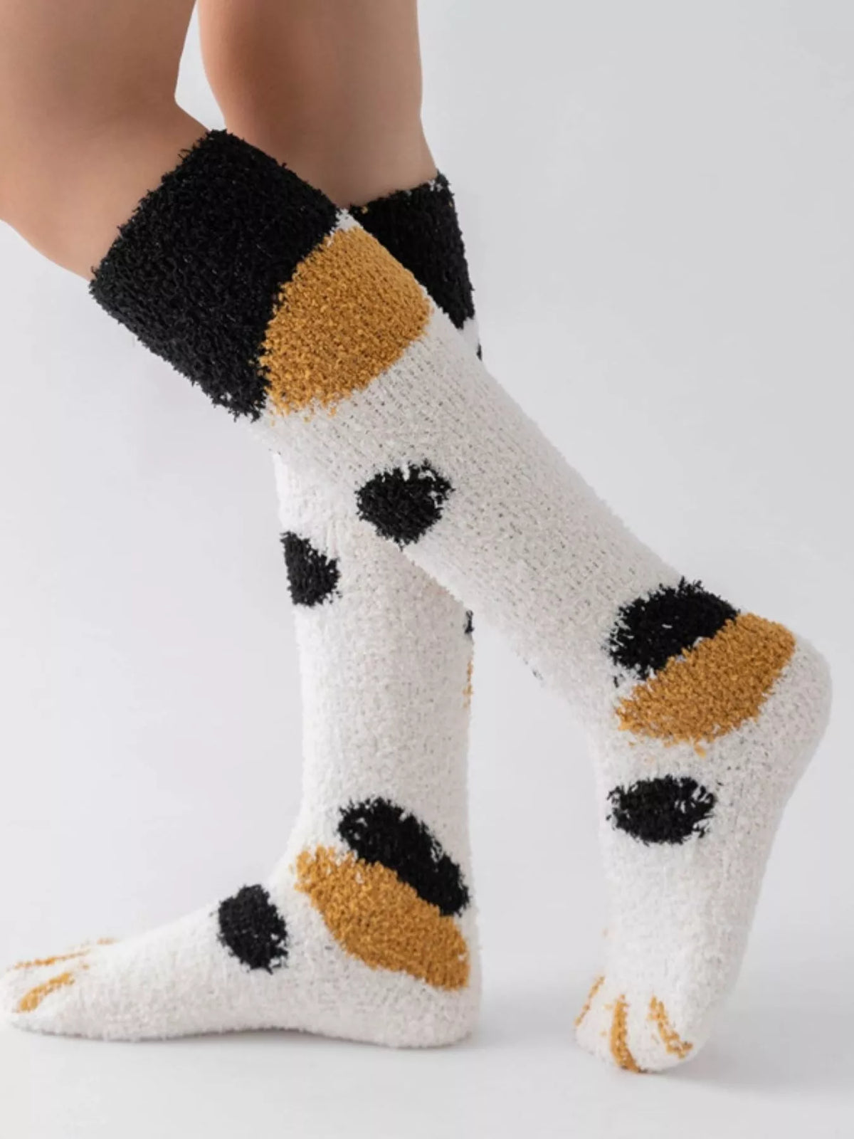 Fuzzy knee-high animal paw socks from Trendsi featuring soft, cozy fabric and playful paw print design.