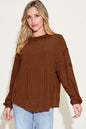 Basic Bae ribbed round neck long sleeve T-shirt by Trendsi, showcasing a close-up of the beige, fitted, ribbed fabric with long sleeves.