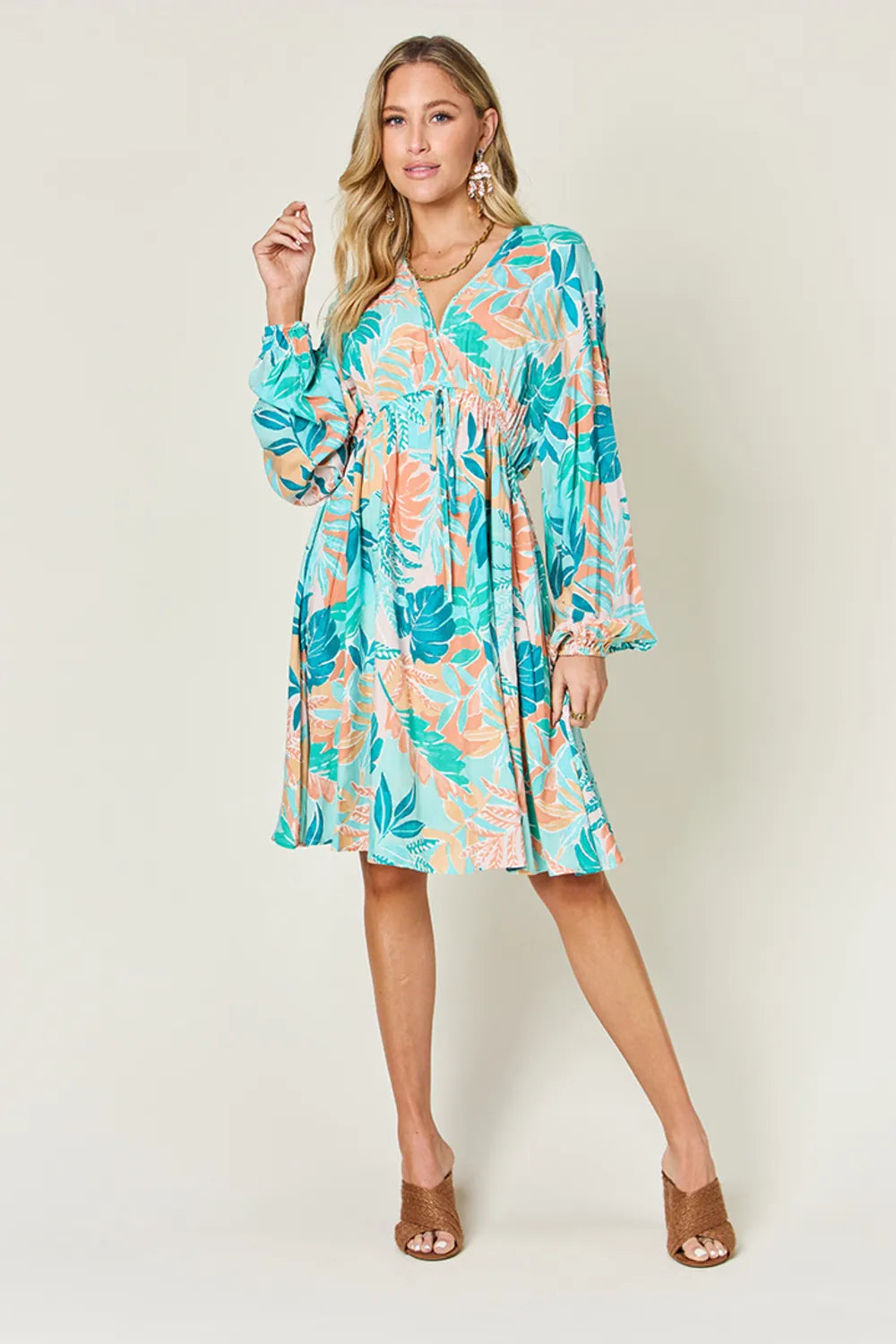 Printed V-neck drawstring dress by Trendsi featuring a full-size design with a stylish, comfortable fit and vibrant pattern.