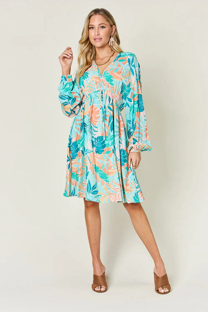 Printed V-neck drawstring dress by Trendsi featuring a full-size design with a stylish, comfortable fit and vibrant pattern.