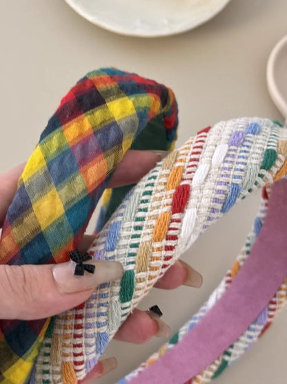 Colorful polyester hair headband with vibrant patterns, stylish accessory for casual or trendy hairstyles by Trendsi.