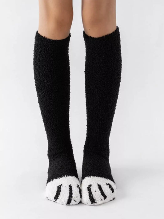 Fuzzy knee-high animal paw socks in soft material, featuring colorful paw print design, perfect for cozy wear.