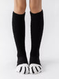 Fuzzy knee-high animal paw socks in soft material, featuring colorful paw print design, perfect for cozy wear.