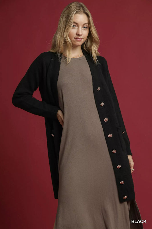 Umgee longline sweater cardigan with button-down front, front pockets, in a cozy knit, styled for casual wear.