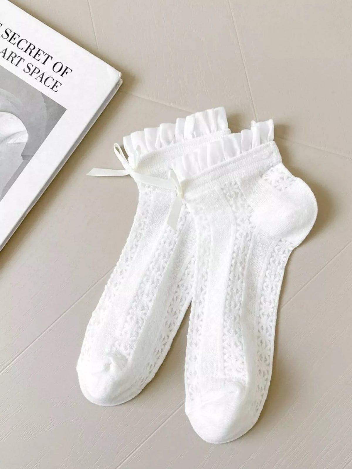 White lace bow socks from Trendsi featuring delicate lace fabric and a charming bow detail at the ankle.