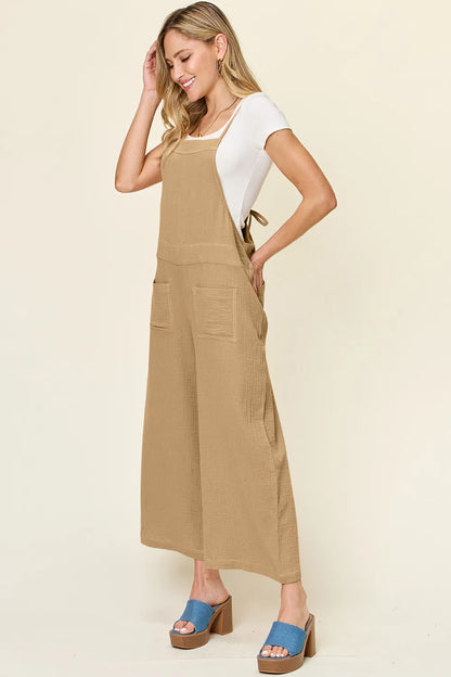 Trendsi Double Take full size texture sleeveless wide-leg overall displayed on model, showcasing its stylish design and relaxed fit.