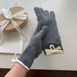Knit gloves with bow decoration from Trendsi featuring cozy fabric and stylish design for cold weather.