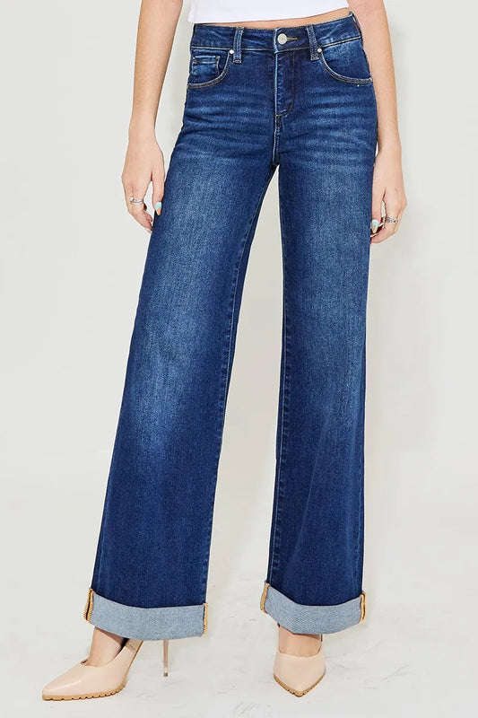 Plus size high-rise wide-leg cuffed jeans with tummy control, trendy fashion by RISEN, featuring a relaxed fit and stylish design.