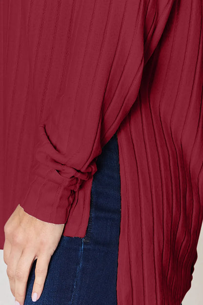 Basic Bae full size ribbed round neck slit T-shirt by Trendsi, featuring a ribbed fabric and a stylish slit detail at the hem.