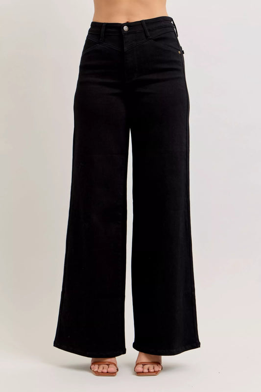Light blue Judy Blue high-waisted wide-leg jeans with front pockets and relaxed fit, showcasing denim texture and stylish design.