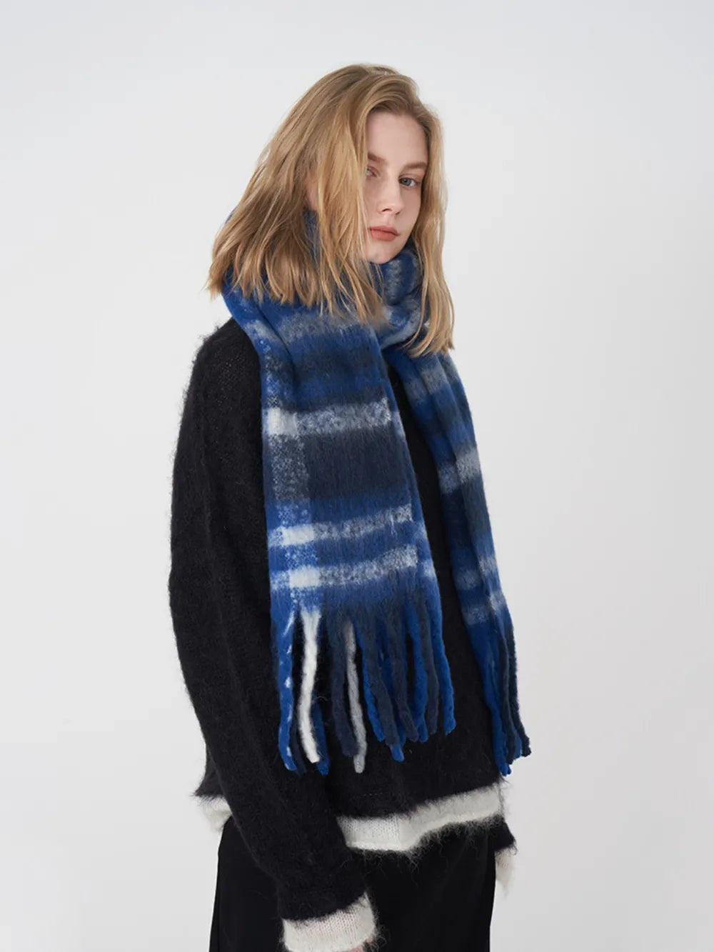 Fringe plaid polyester scarf by Trendsi featuring a stylish checkered pattern and tassel details.