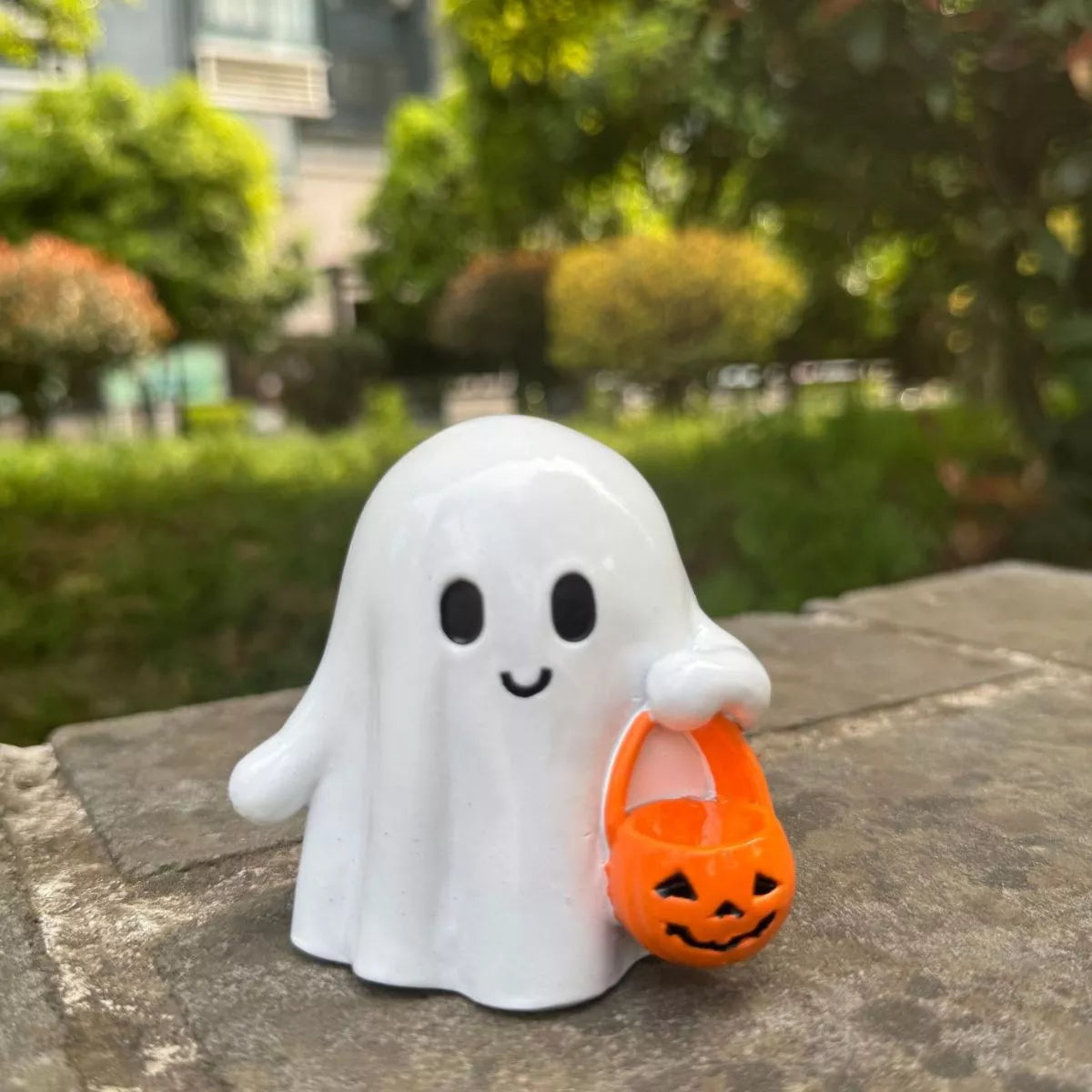 Halloween ghost ornament holding a pumpkin basket, decorative Trendsi Halloween decoration with spooky ghost and pumpkin details.