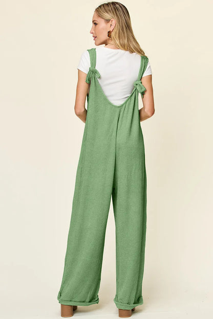 Full view of a Trendsi Double Take full size textured sleeveless wide leg jumpsuit displayed on a hanger.