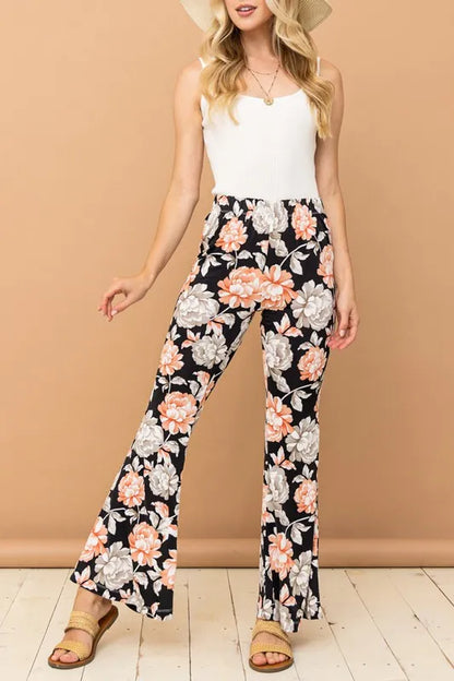 Black wrinkle-free stretch bell bottom flare pants from And The Why by Trendsi, featuring a high-waist fit and wide-leg silhouette.