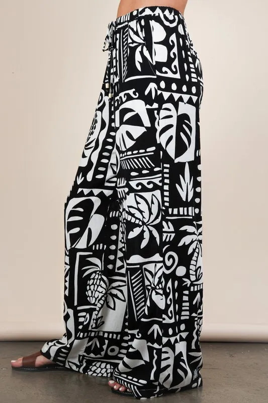 Black Very J printed casual wide-leg resort pants by Trendsi, featuring a relaxed fit and stylish design.