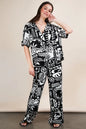 Black Very J printed casual wide-leg resort pants from Trendsi, featuring a relaxed fit and comfortable design.