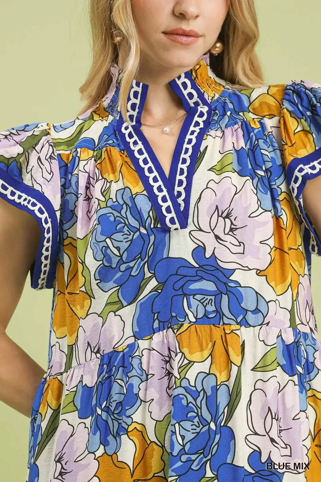 Blue floral tiered midi dress by Umgee with bold mixed floral pattern, perfect for casual or semi-formal occasions.