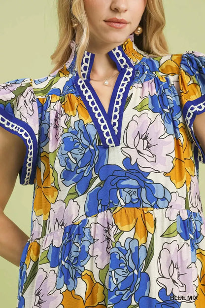 Blue floral tiered midi dress by Umgee with bold mixed floral pattern, perfect for casual or semi-formal occasions.