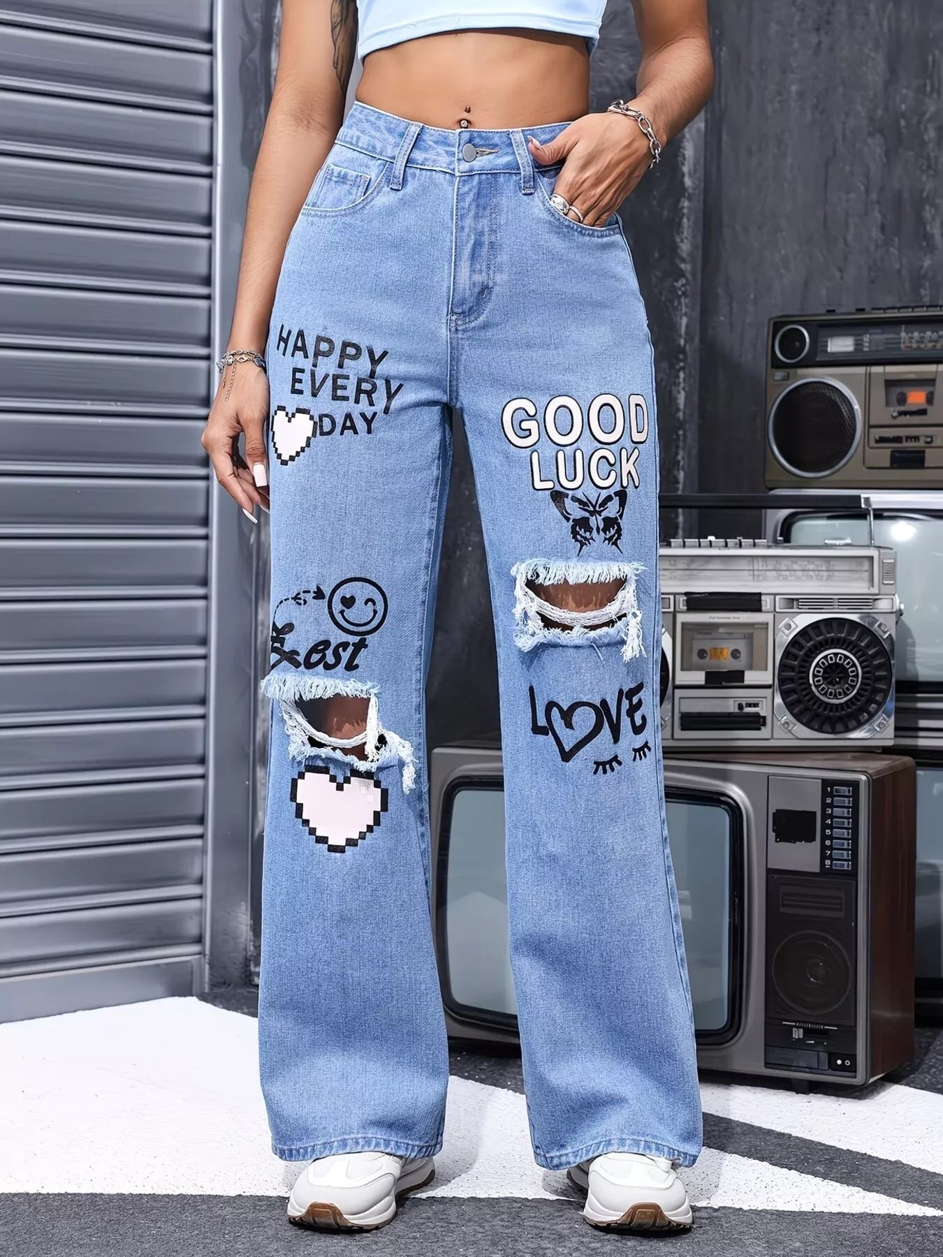 Blue distressed printed wide-leg jeans from Trendsi, featuring a relaxed fit and trendy design for casual wear.