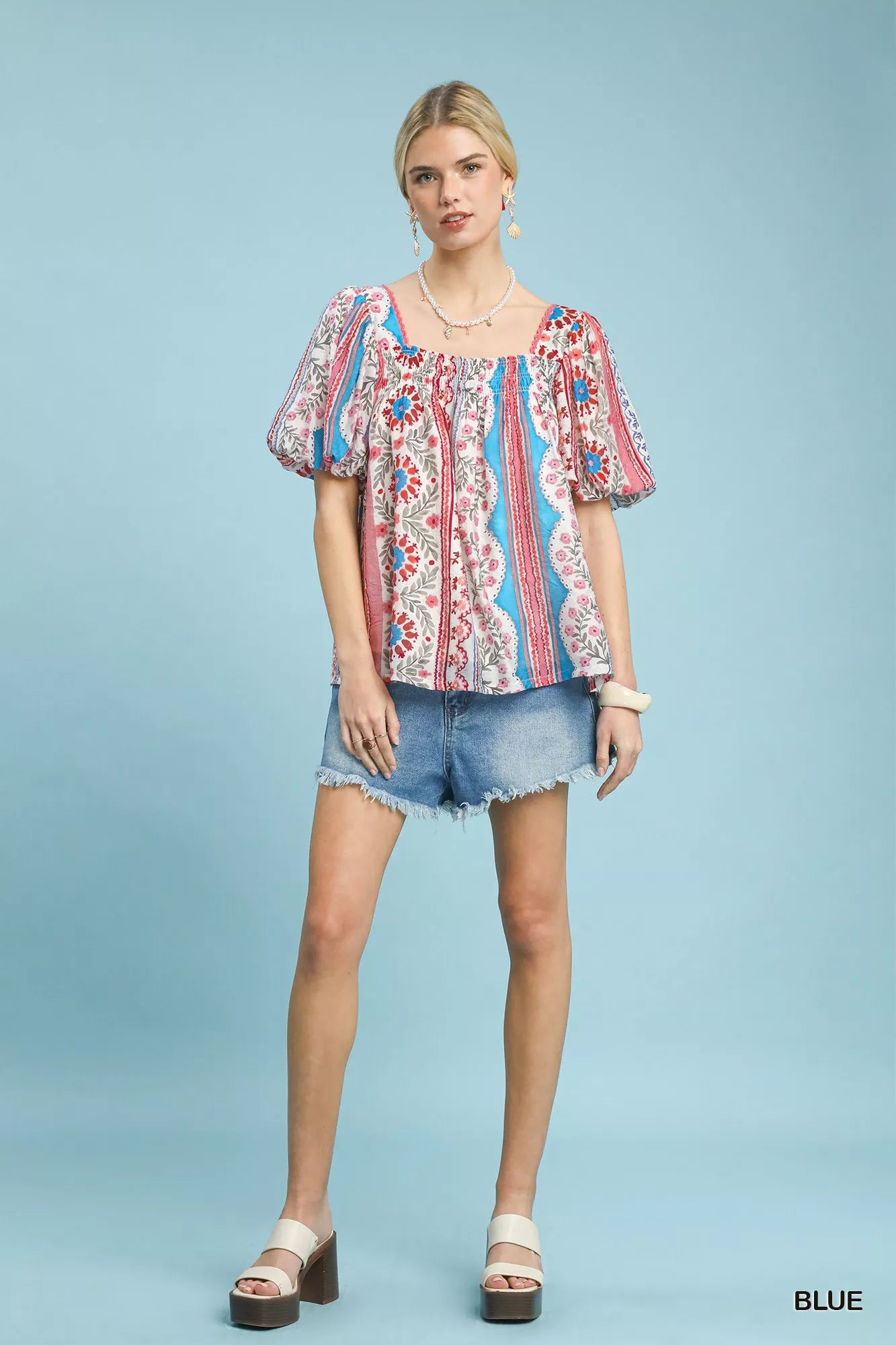 Blue Umgee patchwork puff sleeve smocked blouse with a relaxed fit and detailed stitching, perfect for casual or stylish wear.