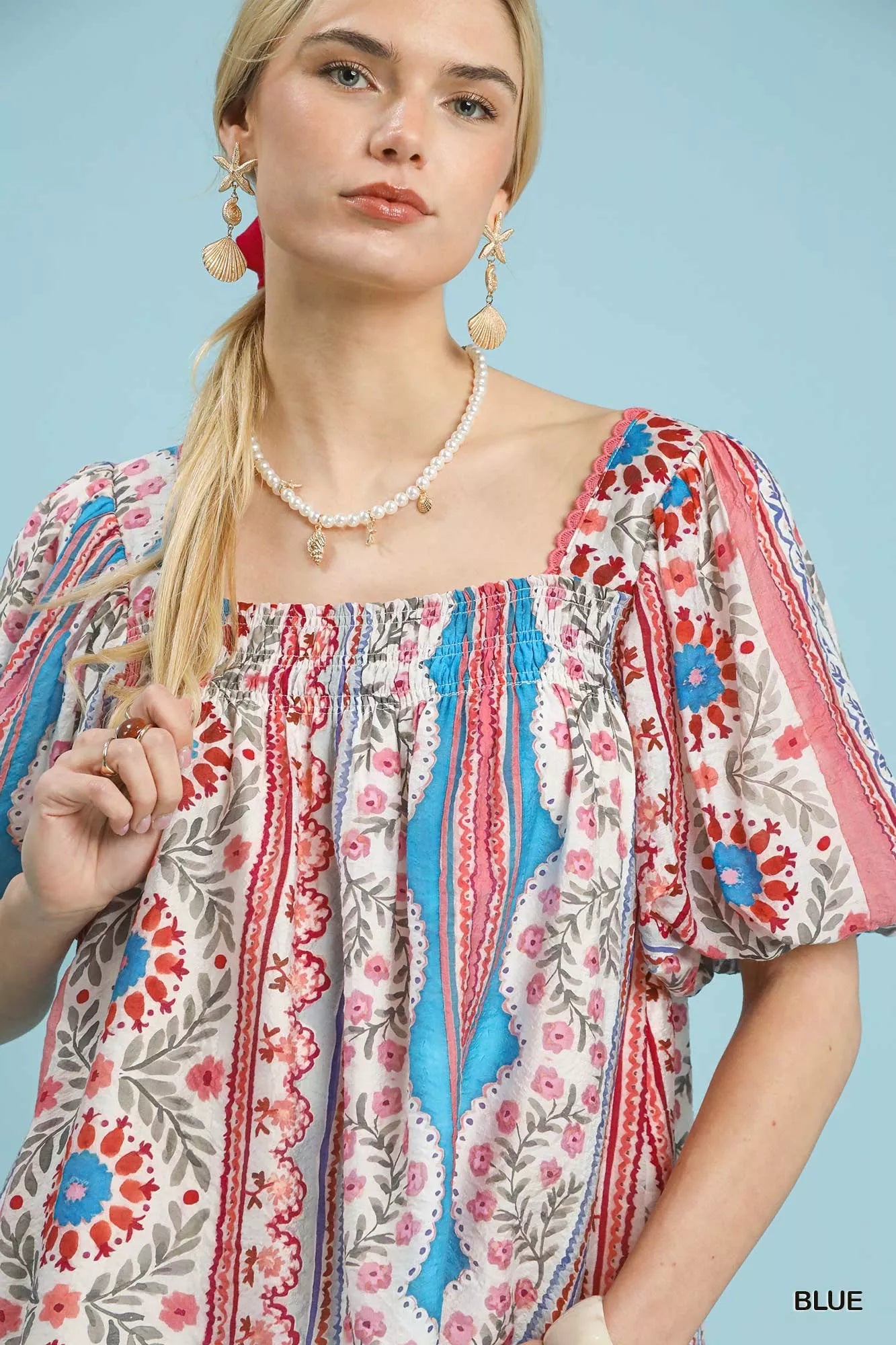 Blue Umgee patchwork puff sleeve smocked blouse with ruffled details, featuring a stylish and comfortable design.