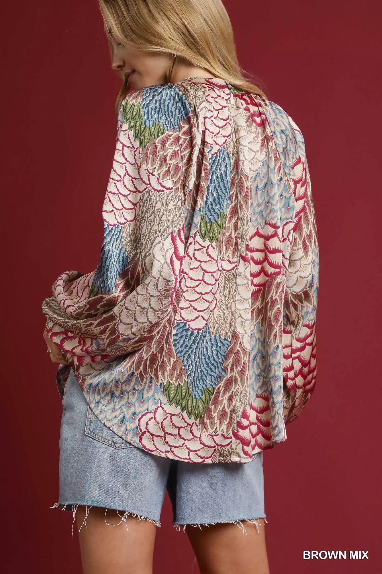 Brown mixed feather print boho peasant blouse by Umgee, featuring relaxed fit and bohemian style with ruffled details.