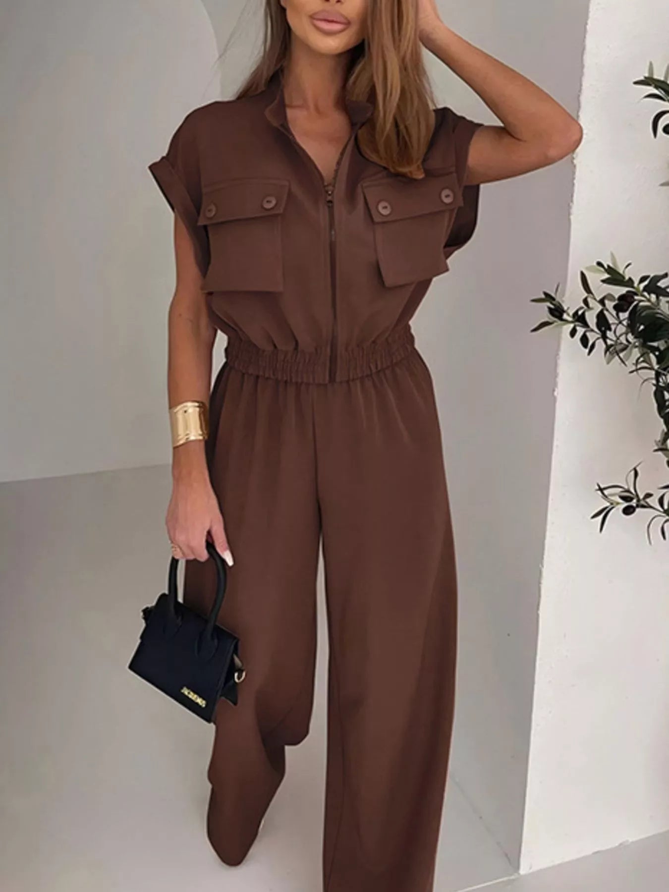 Brown cargo pocket zipper front jumpsuit by Trendsi, featuring side pockets, zipper closure, and a casual, stylish design.