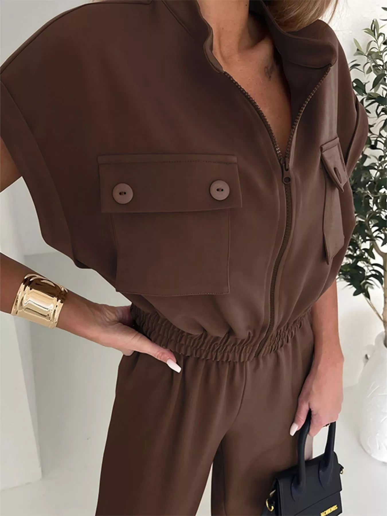 Brown cargo jumpsuit with zipper front and side pockets, featuring a stylish design by Trendsi.