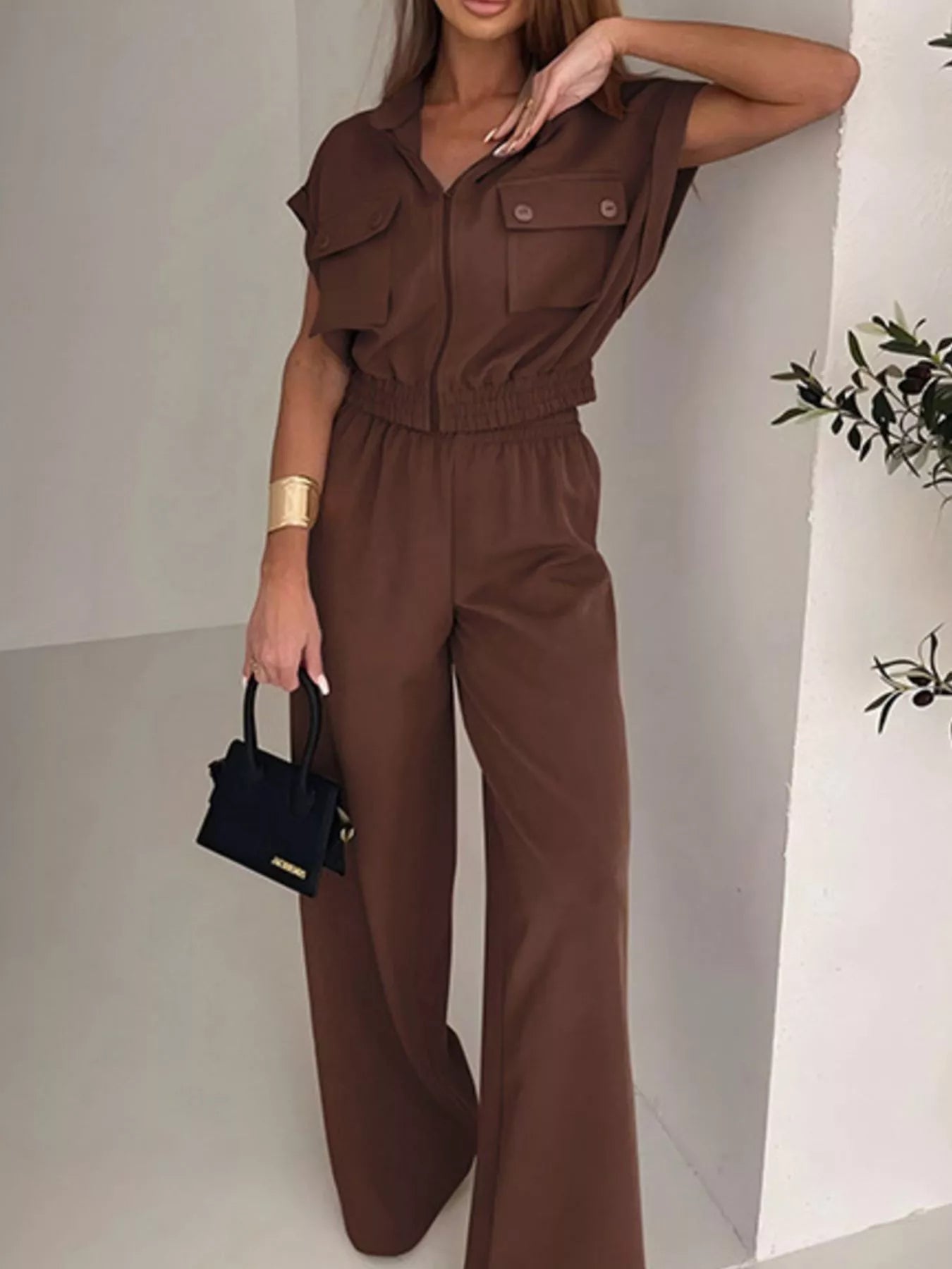 Brown cargo pocket zipper front jumpsuit by Trendsi, featuring a relaxed fit, front zipper, and multiple cargo pockets.
