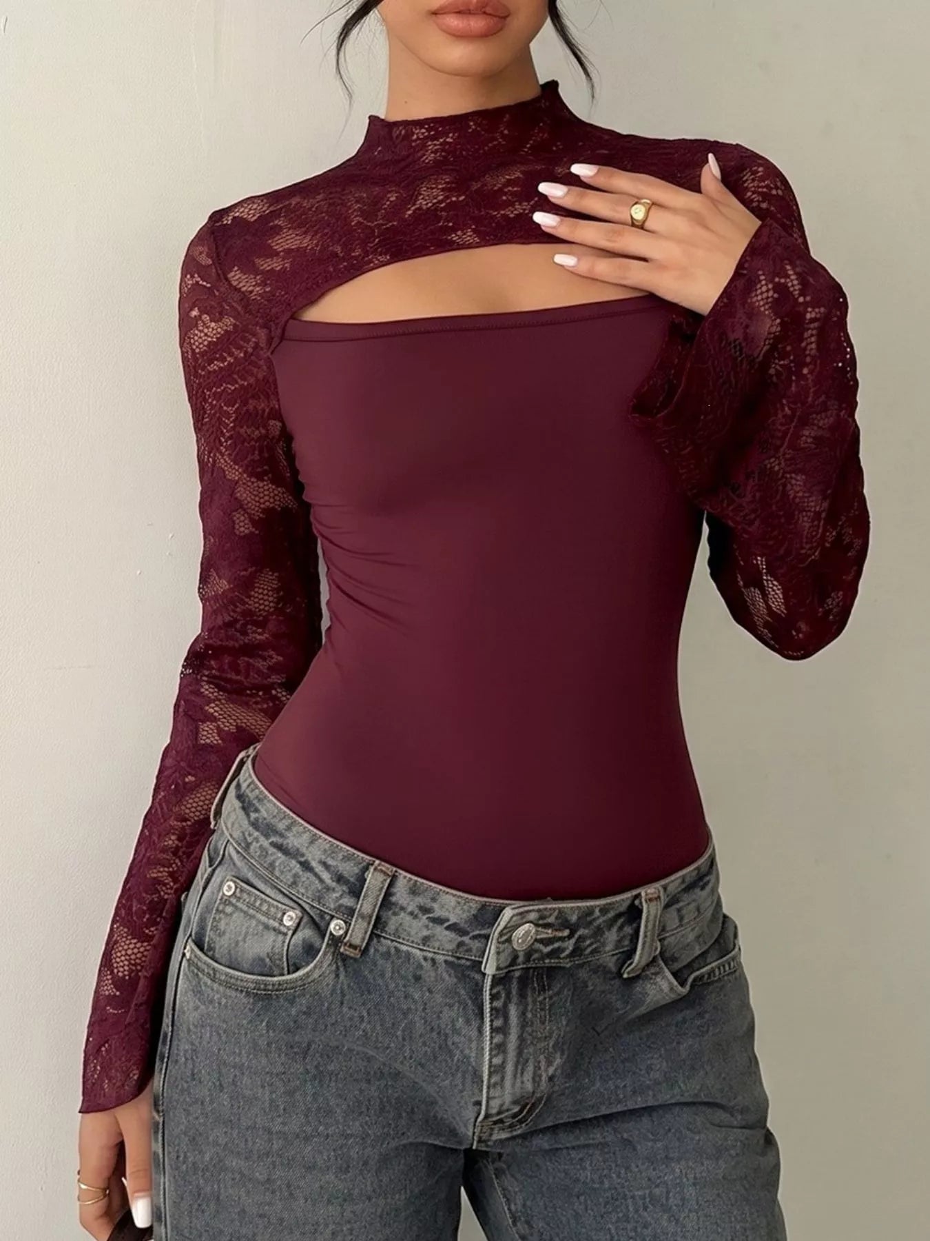 Burgundy lace cut-out flare sleeve bodysuit by Trendsi featuring elegant lace details and stylish flare sleeves.