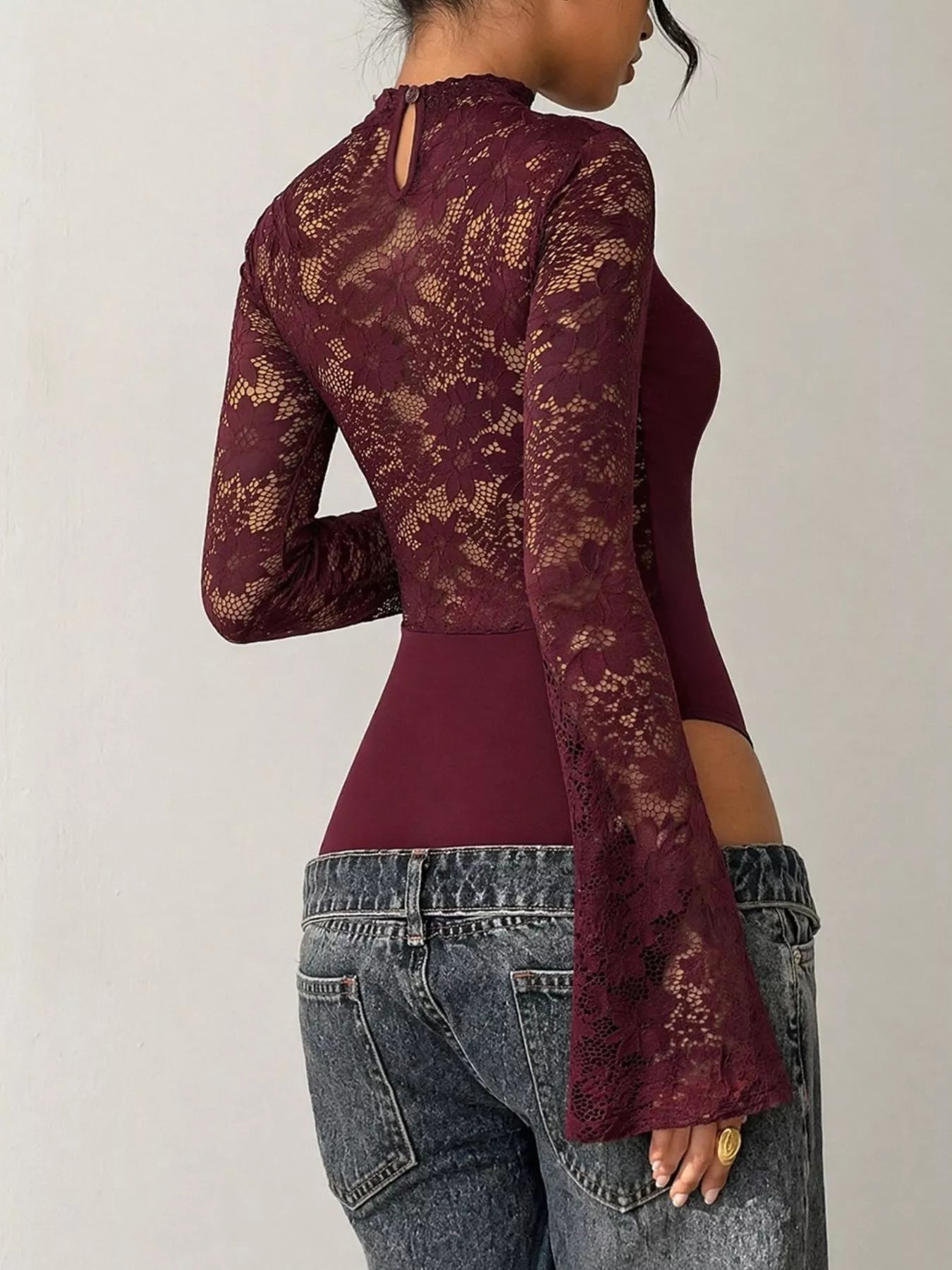 Burgundy lace cut-out flare sleeve bodysuit by Trendsi, featuring elegant lace details and stylish flare sleeves.