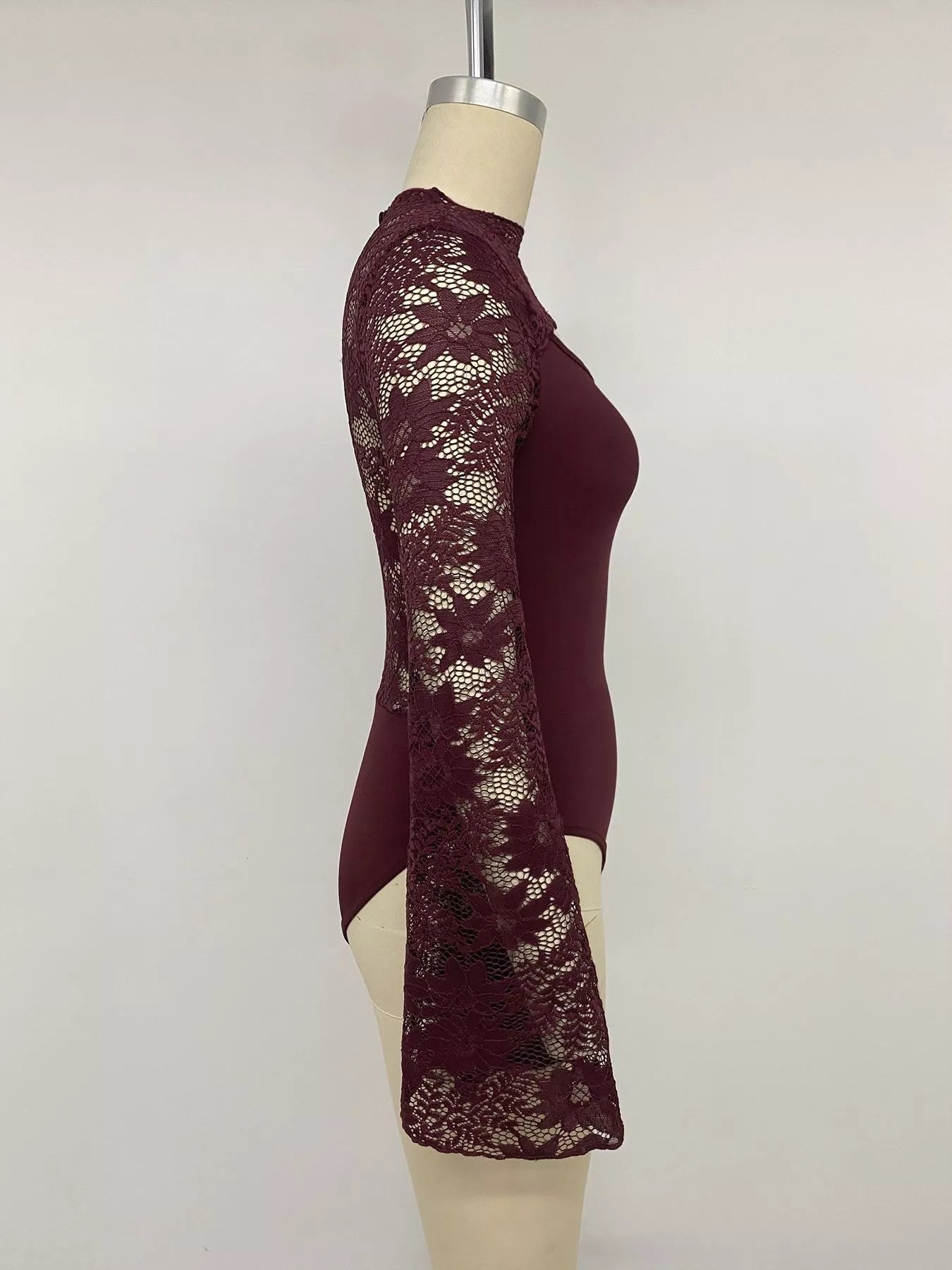 Burgundy lace cut-out flare sleeve bodysuit by Trendsi featuring intricate lace details and stylish flare sleeves.
