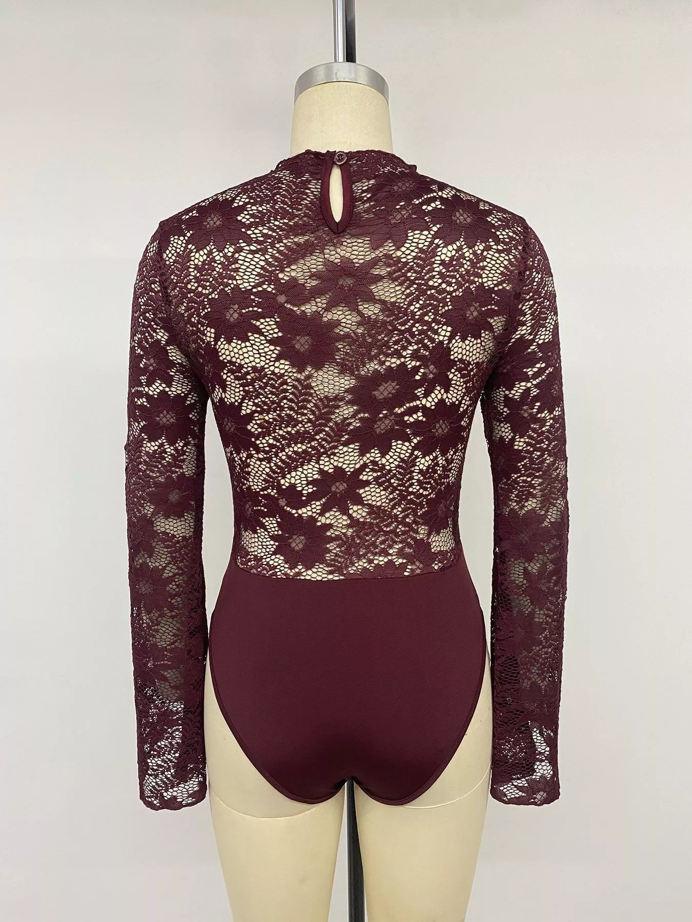 Burgundy lace cut-out flare sleeve bodysuit by Trendsi, featuring elegant lace details and stylish flare sleeves.