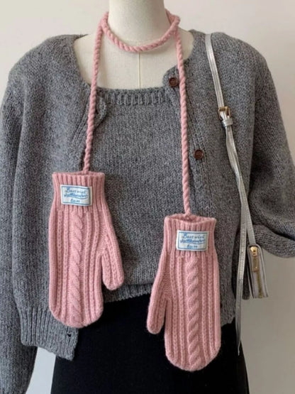 Cable knitted mittens with neck strap from Trendsi, showing cozy, textured wool design and attached strap for warmth and style.