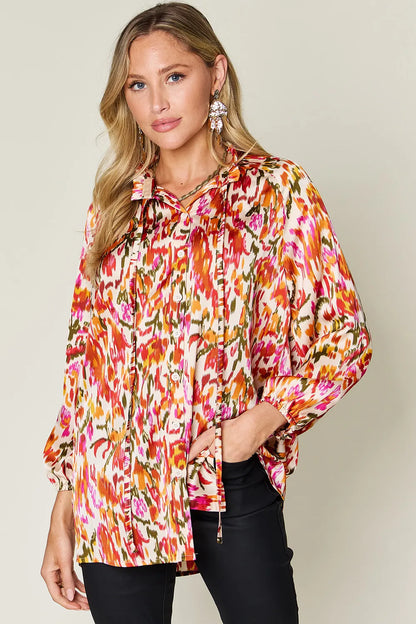 Plus size printed button-up long sleeve shirt from Trendsi, featuring a stylish double take full size design and vibrant pattern.