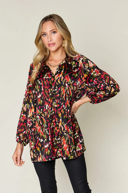 Plus size printed button-up long sleeve shirt from Trendsi, featuring a stylish full-size design and vibrant pattern.