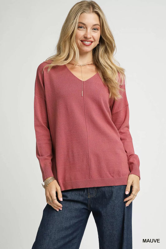 Trendsi Umgee V-neck high-low hem knit top with side slit, featuring a relaxed fit and soft fabric in a stylish casual design.