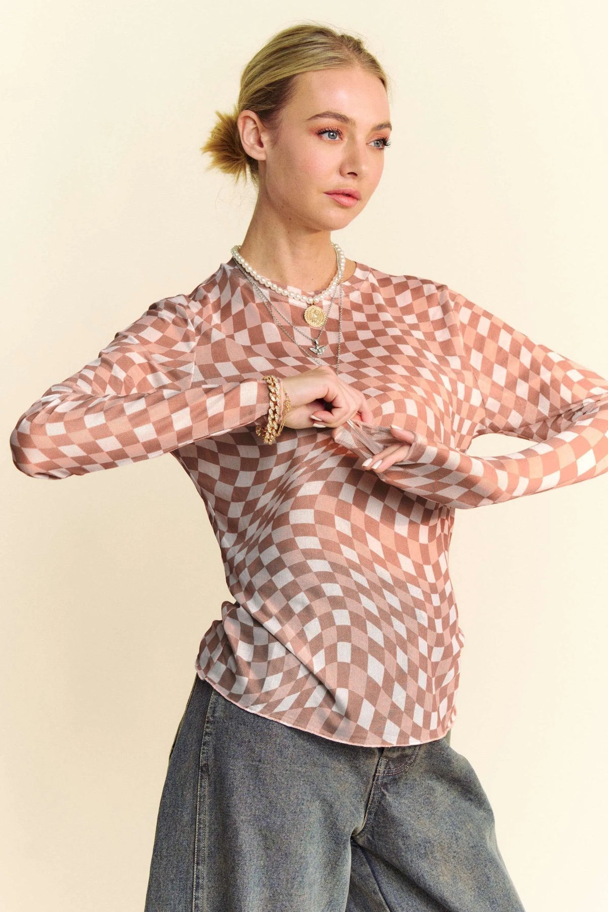 Davi & Dani checker board mesh long sleeve layering top by Trendsi, featuring a black and white checkered pattern and lightweight fabric.