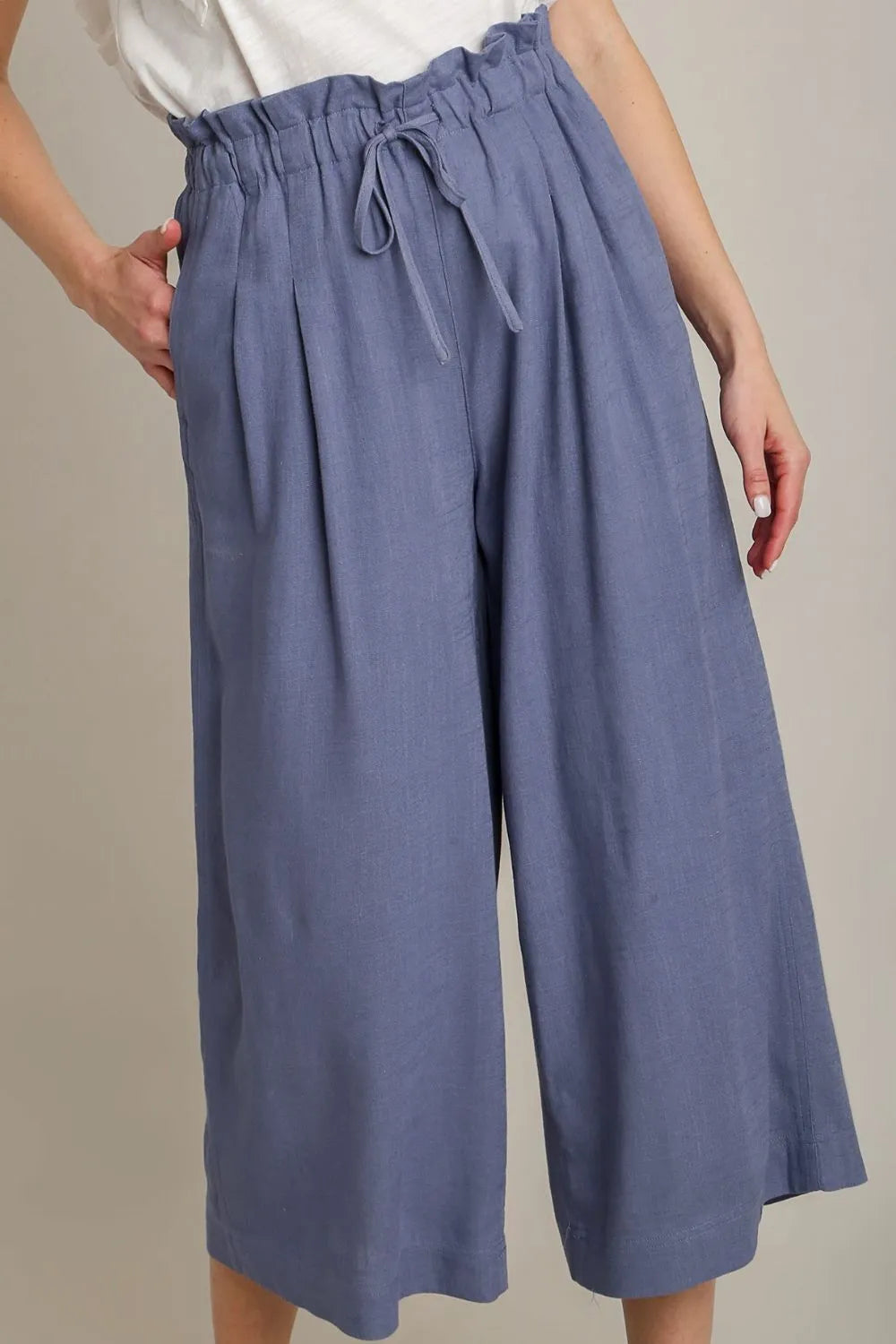 Plus size linen wide fit pants with drawstring from Umgee, featuring a relaxed style and full length in natural fabric.